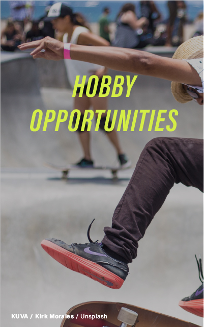 "A skateboarder mid-jump at a skate park with other participants in the background, emphasizing the opportunities to engage in hobbies."